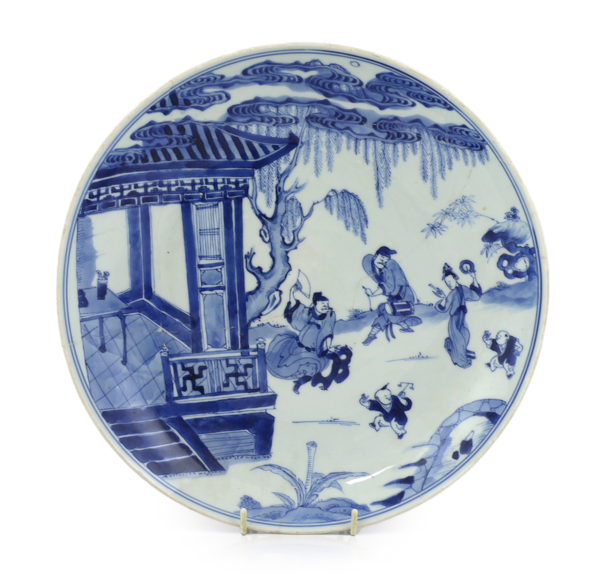 A Chinese blue and white dish, Kangxi period, broken and messily reglued